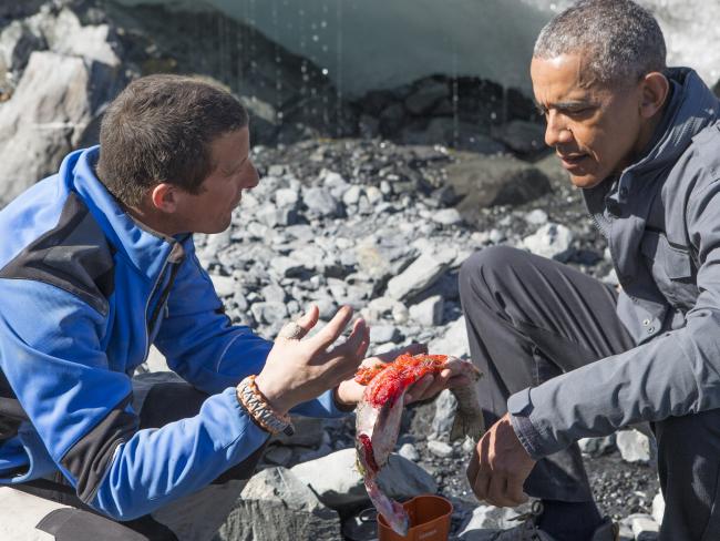 President Barack Obama and wilderness survival expert Bear Grylls demonstrate to students how to catch and gut wild salmon amidst a poor job market.